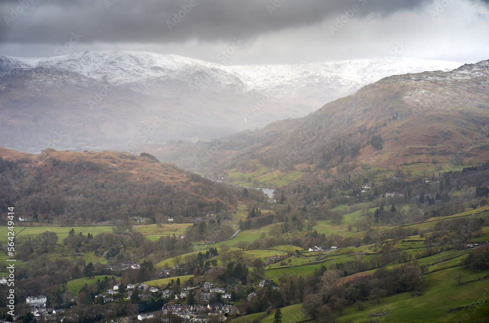 Naklejka premium The snow covered Mountain summit of High Raise with Nab Scar on the right from Wansfell Pike in the Cumbrian Lake District Mountains, England UK.