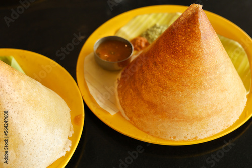 Idly Dosa ghee roast with coconut chutney sambar popular South Indian Breakfast, Kerala, Tamil Nadu India. Top view of Masala dosa, a type of pancake stuffed with potato and tomato curry side dish. photo