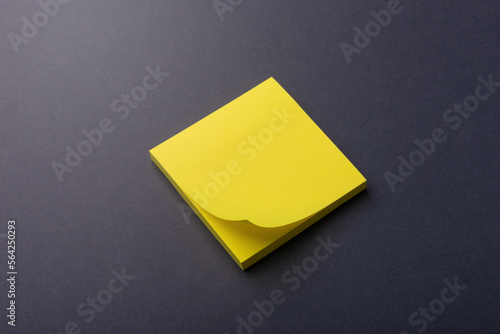 A stack of yellow office sticky notes on a gray surface. Minimalist business composition. Planning. Business concept.