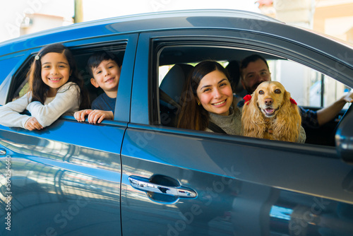 Excited family in the car with a cocker spaniel dog