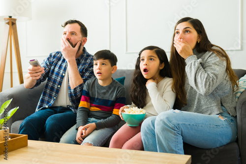 Family looking surprised watching a fun movie