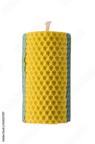 Candle isolated on white background. Scented handmade yellow and blue beeswax aroma candle. Natural wax with texture of honeycomb bees. Element of interior for decor, romance cozy spa. Aromatherapy.