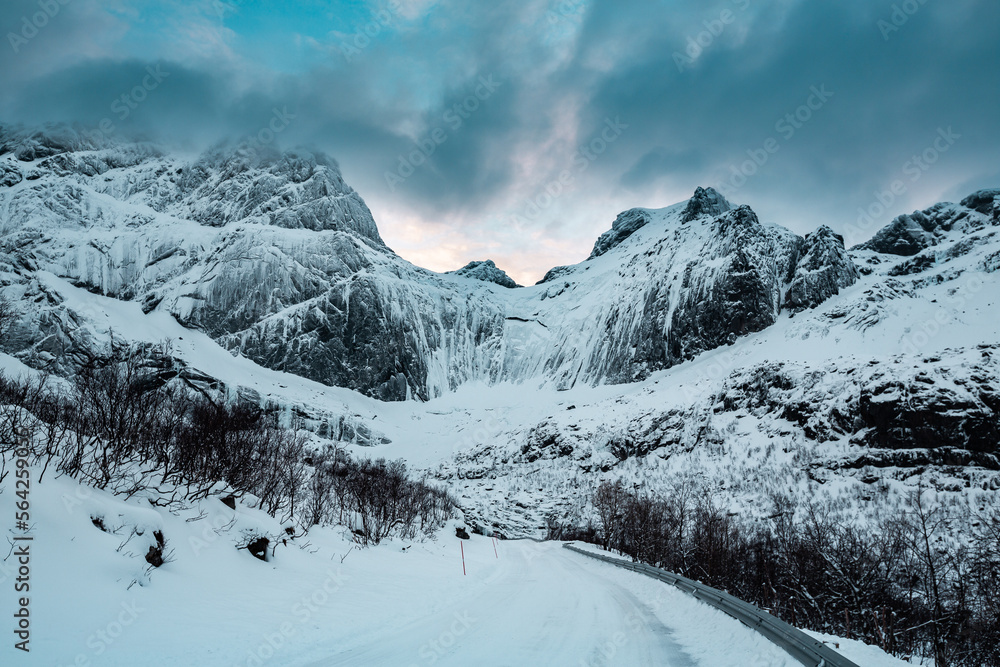 Fototapeta premium Sunny winter day in Reine, fishing village in Norway, drone shot on amazing landscape in Lofoten. Lovely clouds and blue sky.