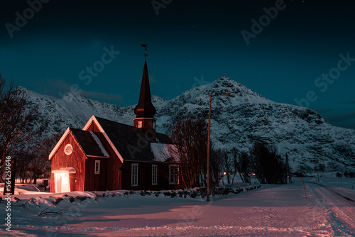 Church in Lofoten, Norway Flakstad during night with stars and mountains in background  photo