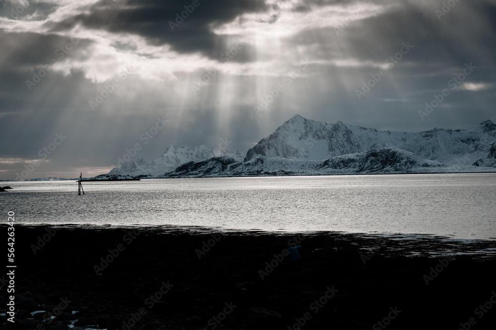 Unbelievable conditions in Lofoten, Norway. Playing lights, sun with clouds with mountains, amazing epic scenery during sunset 