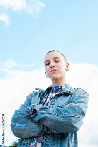 Young woman with shaved hair empowered and with an attitude of strength. Concept: feminism, empowerment