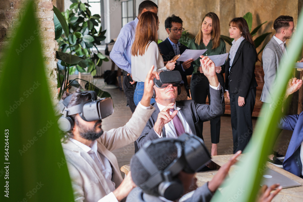 Group of business people doing virtual reality activities while other