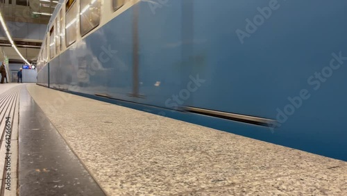 Blue train arriving at subway station in Munich city. Underground transportation concept