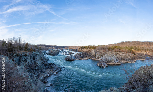 A wide-angle photo of Great Falls National Park in the winter during sunset.
