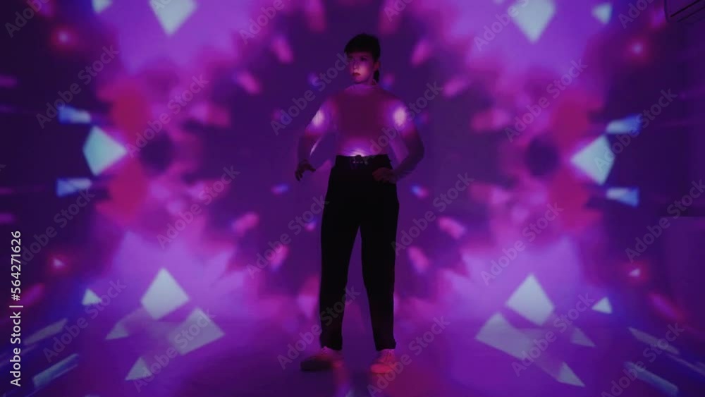 dance and light performance, woman dancing like robot, bright psychedelic lights on wall dance and light performance, woman dancing like robot, bright psychedelic lights on wall