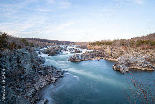 A wide angle long exposure photo of Great Falls National Park in the winter during sunset. photo