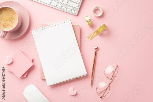 Valentine's Day concept. Top view photo of notepads pen stylish glasses decorative tape hearts sticky note paper keyboard and cup of hot drinking on isolated pastel pink background with copyspace