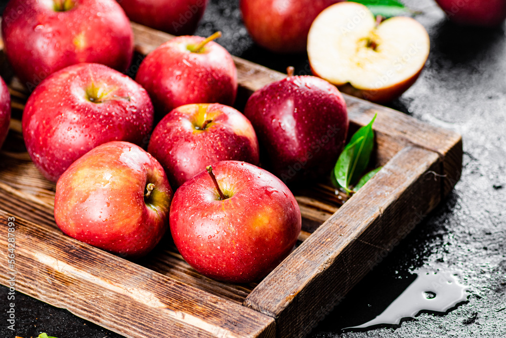 Ripe red apples on a wooden tray. Ripe red apples on a wooden tray.