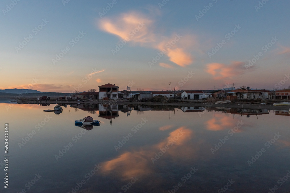 Fototapeta premium View of boats on sunset with reflection on the sea, colorful sky and clouds on sunset time with silhoutte of vehicles