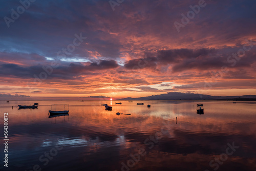 View of boats on sunset with reflection on the sea  colorful sky and clouds on sunset time with silhoutte of vehicles