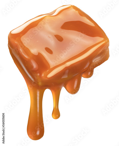 Caramel candy and drops of milk caramel sauce flowing down from it. File contains clipping path. photo