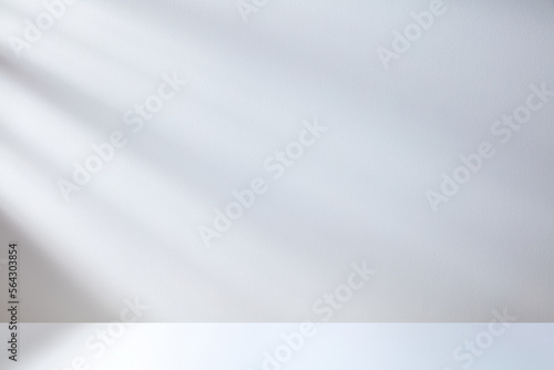 white table background white wall with shadow from light rays photo