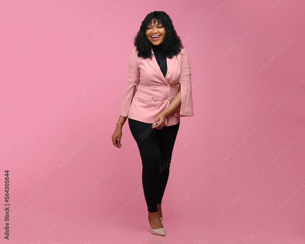 Full length view of confident cheerful african american businesswoman walking over a Pink background Full length view of confident cheerful african american businesswoman walking over a Pink background