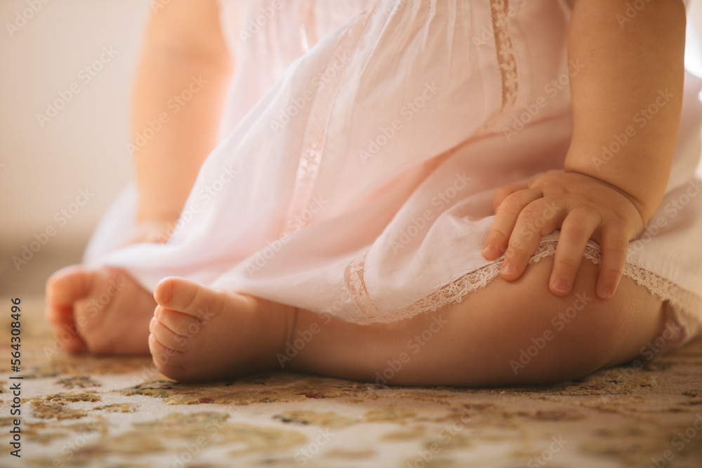 Anonymous baby sitting on floor Anonymous baby sitting on floor