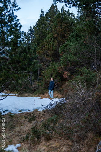 Young guy walking in nature in winter.
