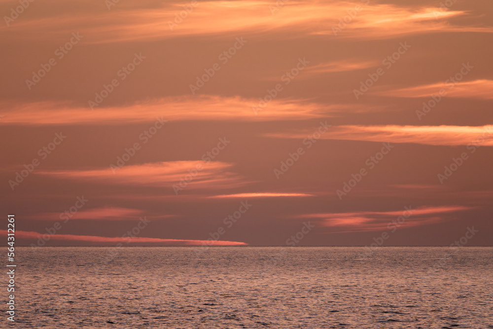 Sea waves at sunset. Evening sky over the sea.
