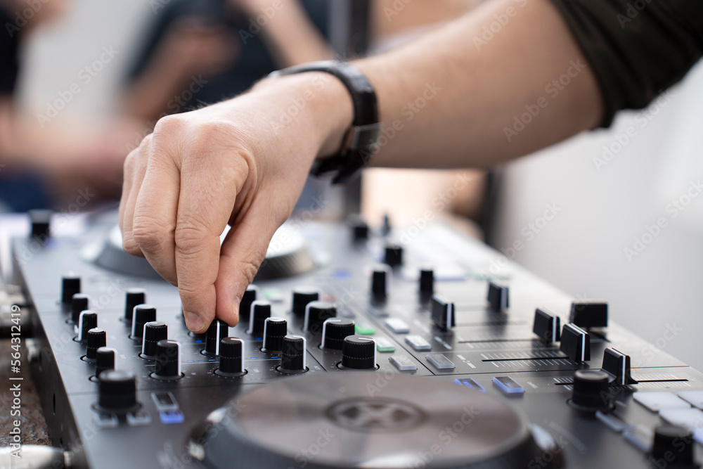 Dj mixing music outdoor at beach party festival - Close up of sound mixer equipment - Focus on hand - Fun, millennials generation, youth lifestyle, entertainment and fest concept Dj mixing music outdoor at beach party festival - Close up of sound mixer equipment - Focus on hand - Fun, millennials generation, youth lifestyle, entertainment and fest concept