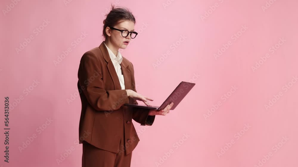 Young girl, employee, manager checking projects on laptop, working, emotionally looking over pink studio background. Concept of youth, beauty, fashion, lifestyle, emotions, facial expression. Ad Young girl, employee, manager checking projects on laptop, working, emotionally looking over pink studio background. Concept of youth, beauty, fashion, lifestyle, emotions, facial expression. Ad