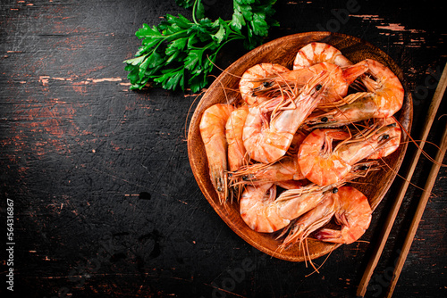 Cooked shrimp in a plate with parsley.