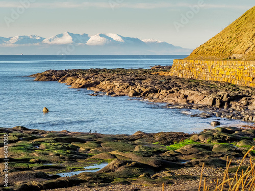 View looking towards the snow capped peaks of the Isle of Arran from Troon shores photo