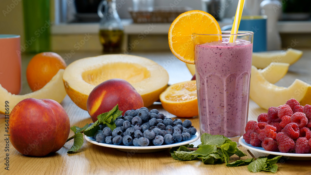 Raspberry Blueberry Melon Smoothie into a glass on the background of fresh fruits Raspberry Blueberry Melon Smoothie into a glass on the background of fresh fruits