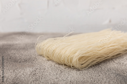 Rice noodles with rice flour on a black textured background.Close-up. Place for text. Copy space.