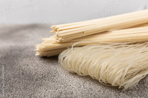 Rice noodles with rice flour on a black textured background.Close-up. Place for text. Copy space.