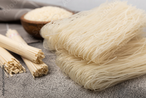 Rice noodles.Rice and noodles with rice flour in a wooden plate on a black background.Close-up. Place for text. Copy space.