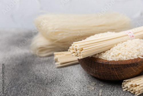 Rice noodles.Rice and noodles with rice flour in a wooden plate on a black background.Close-up. Place for text. Copy space.