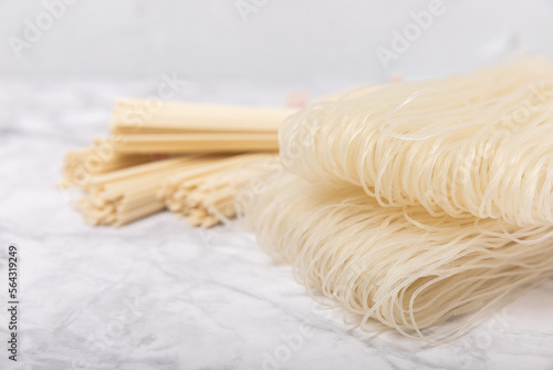 Rice noodles.Rice flour noodles on a white marble background.Close-up. Place for text. Copy space.