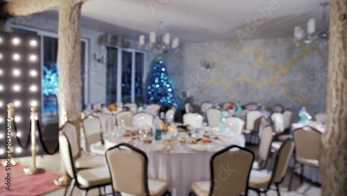 Slow motion video of the New Year (Christmas) table decoration. Against the backdrop, the illumination of the Christmas tree glitters