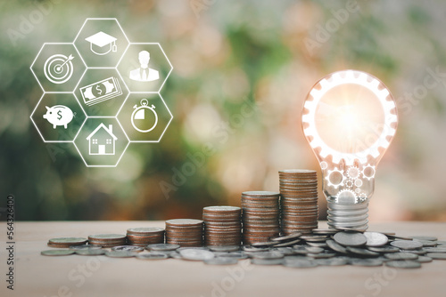 Stacking of coin and Energy saving light bulb step up growing growth saving money with icons about education, business strategy.Concept of saving money for future use and business success goal concept