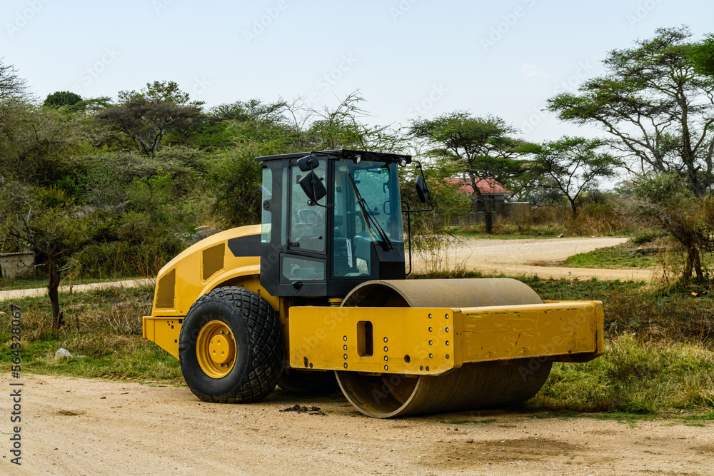 Yellow road roller at construction site