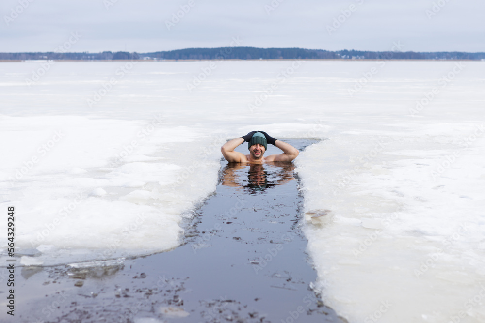 Winter swimming. Woman in frozen lake ice hole. Swimmers wellness and