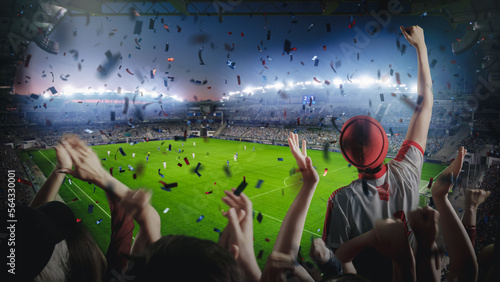 Establishing Shot of Fans Cheer for Their Favorite Team on a Stadium During Soccer Championship Match. Team Scores Goal, Crowds of Fans Shout, Celebrate Victory with Confetti. Football Cup Tournament.
