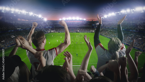 Establishing Shot of Fans Cheer for Their Favorite Team on a Stadium During Soccer Championship Final Match. Teams Play, Crowds of Fans Celebrate Victory and Goal. Live Football Cup Tournament.