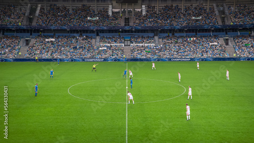 Soccer Football Championship Stadium with Crowd of Fans: Blue Team Starts The Game With Kick Off, Beginning of International Tournament Finals. Sport Channel Broadcast Television Concept. High Angle. © Gorodenkoff