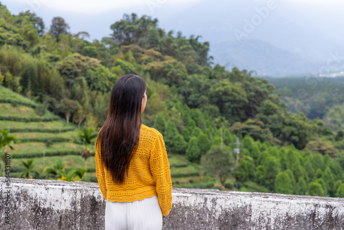 Travel woman look at the tea tree field
