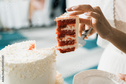 bride cuts first piece of wedding cake