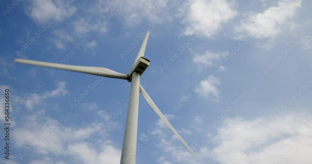 White wind turbine spin over the blue sky White wind turbine spin over the blue sky