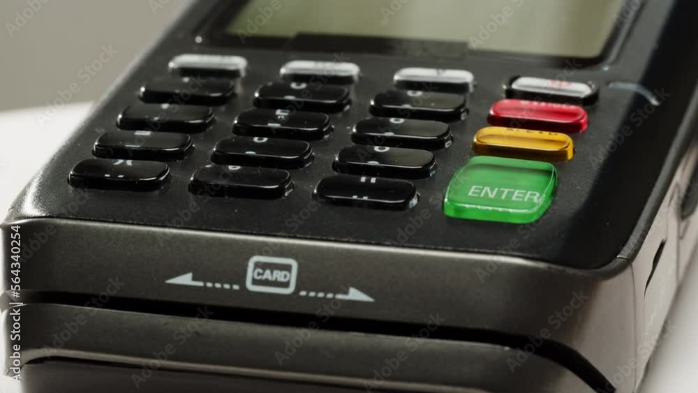 Close up of NFC terminal in the shop. Macro shot of Men pays by card in banking terminal. Close up of NFC terminal in the shop. Macro shot of Men pays by card in banking terminal.