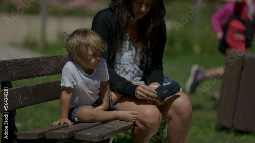 Candid mother putting socks into child feet parenting clothing concept