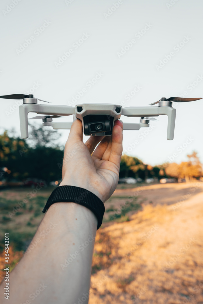 Person Holding a Drone in the Air