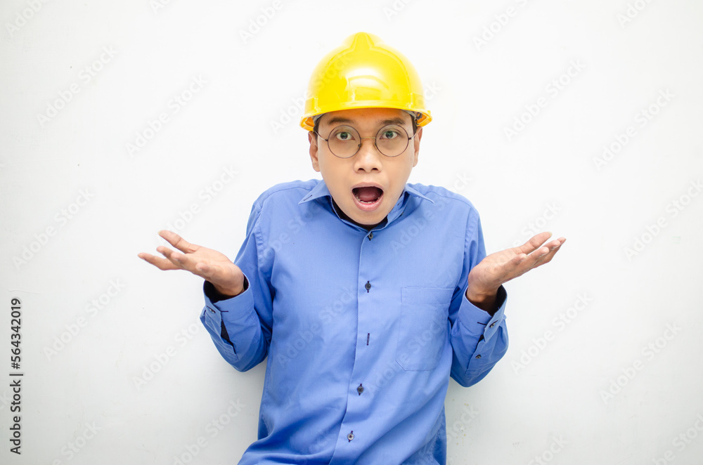 Young Asian man construction worker in yellow safety helmet unsure of what to choose with hand pointing left or right, isolated over whote background. advertising model for billboards. Young Asian man construction worker in yellow safety helmet unsure of what to choose with hand pointing left or right, isolated over whote background. advertising model for billboards.