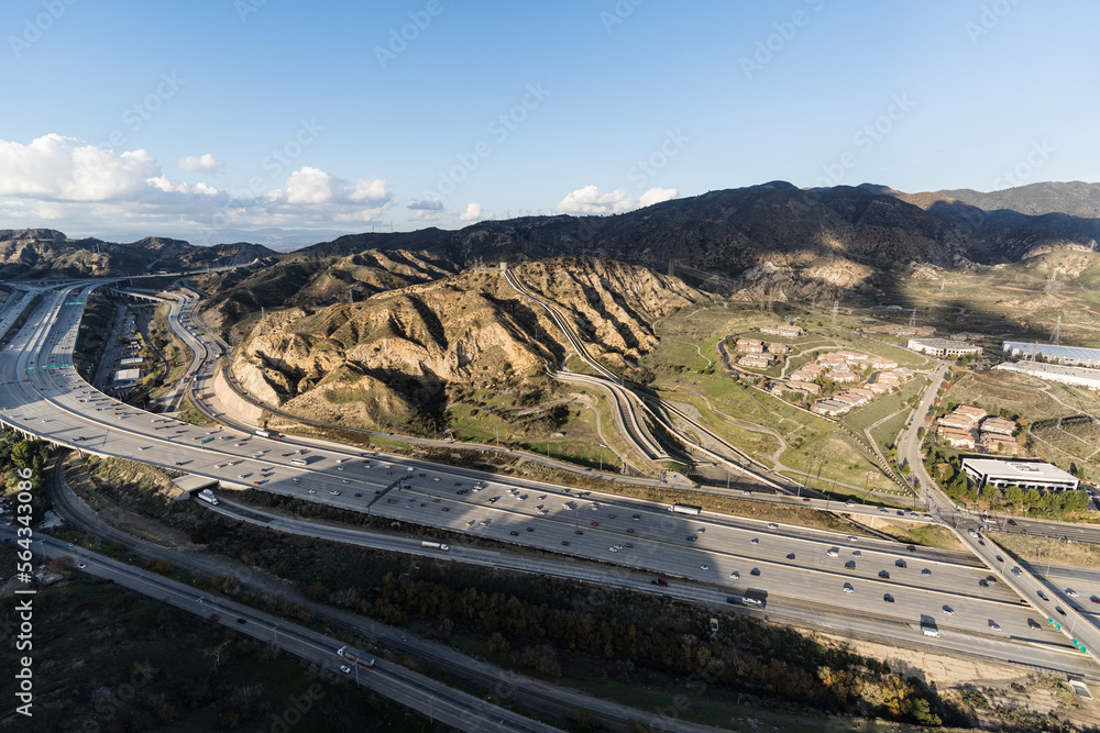 Fototapeta premium Aerial view of the Interstate 5 freeway and Los Angeles aqueduct cascades near the San Fernando Valley and Santa Clarita in Southern California.